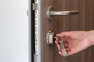 Person using keys and locking apartment door.