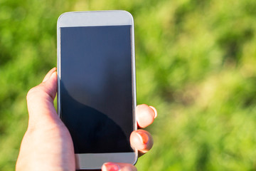 Woman touching a screen of her smarthone 