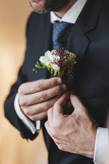 Detail of groom getting ready for wedding ceremony