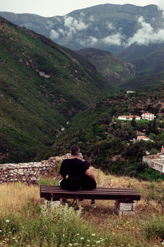 Father and son sitting against mountains. Fathers day concept