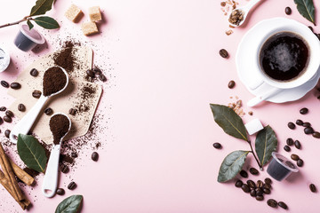 Food background with assorted coffee, coffee beans, ground and capsules, green leaves, copy space, top view. Retro style toned.
