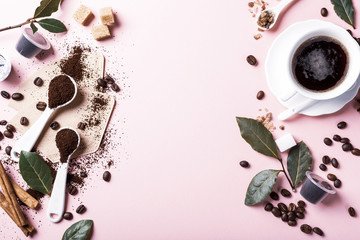 Food background with assorted coffee, coffee beans, ground and capsules, green leaves, copy space, top view. Retro style toned.