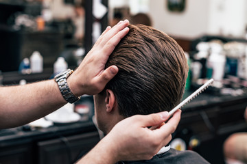 Fototapeta premium Men's haircut and styling in barbershop. Stylish Haircut Haircut.
