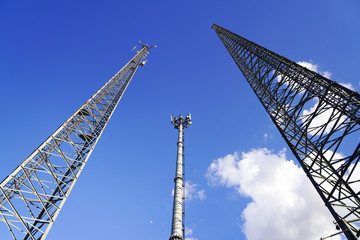 3 mobile phone base stations with blue sky background in Turkey. Competition for mobile phone users.