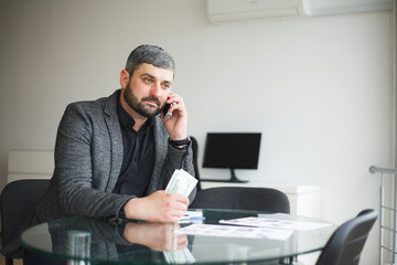 Business Man Sitting at the Desk and Signing Contract. Man takes Bribe for Signing the Contract. High Resolution