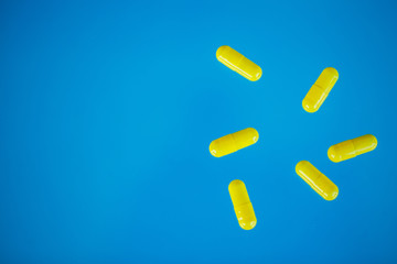 Medical Pills. Colored Pills And Capsule On Blue Background. Pharmacy Theme, Capsule Pills With Medicine Antibiotic in Packages