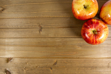 Red apples waiting to be eaten on the kitchen table