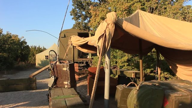 Military Camp with the Tent, Radioset at the Sunset