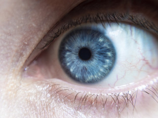 Intense blue eye from a man, looking down - close up with details