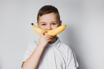 boy holding a banana in hand