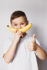 boy holding a banana in hand