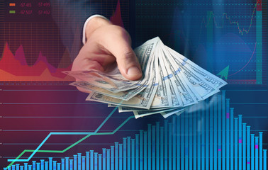 Businessman holding bribe on black background
