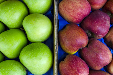 Pile of fresh ripe green, red apples in a local market