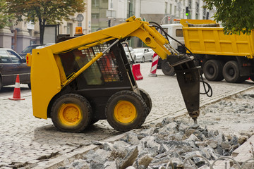 machine hydraulic jackhammer at the object road repair in the city