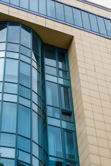 Obraz premium building facade with blue glass windows with tiles, vertical frame
