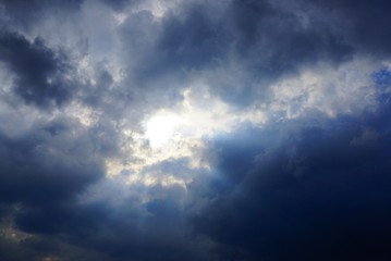 Naklejka na ściany i meble large gray black clouds on a bright sky