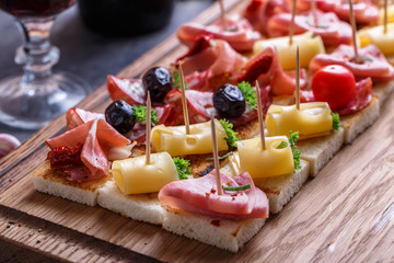 Crostini with prosciutto, ham, sausage and cheese.