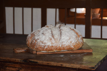 hand-baked bread sprinkled with flour in the middle ages in an old cottage