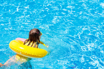 Child in swimming pool. Kids swim. Water play.