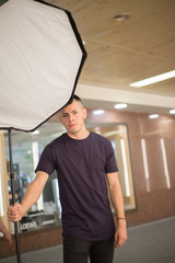 Fototapeta premium young photography technician holding the equipment