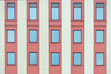 Colourful red fasade wall with columns and windows texture