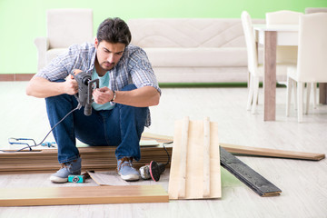 Man laying flooring at home