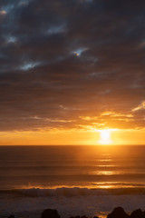 Naklejka na ściany i meble Brilliant golden sunrise over ocean