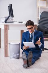 Young handsome businessman employee working in office in paperwo
