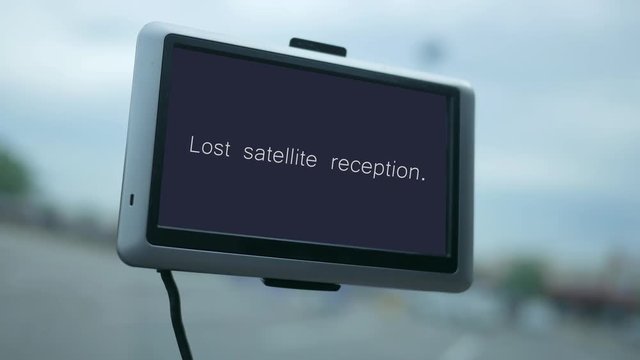 Modern GPS screen in a car dashboard with text - lost satellite reception