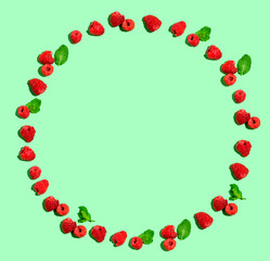 Raspberries and mints on a solid color background