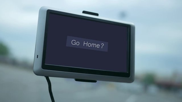 Modern GPS screen in a car dashboard with text - Go Home