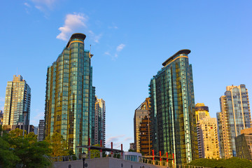 Fototapeta na wymiar Vancouver city skyscrapers at sunrise in summer. Coal Harbor waterfront modern buildings.