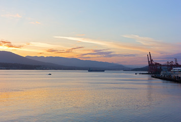 Vancouver Harbor panorama at sunrise. Sunrise over mountains with a view on North Vancouver and city port.