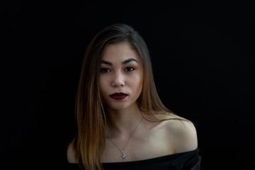 Girl on a black background. Portrait