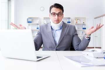 Businessman with neck injury working in the office