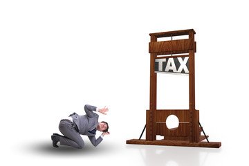 Businessman in heavy high taxes business concept