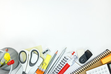 assortment of stationary and writing tools for office on white table background