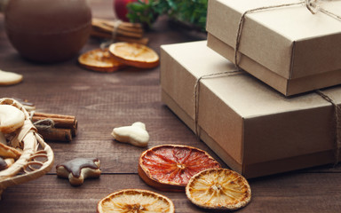 Top  view  of Christmas background. Christmas presents,cookies and dry oranges on a brown wooden table.