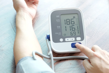 Man check blood pressure monitor and heart rate monitor with digital pressure gauge. Health care...