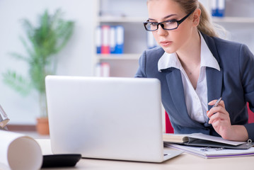 Businesswoman working at her desk in office