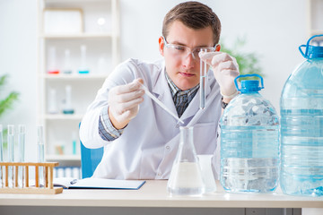Fototapeta premium Young chemist student experimenting in lab
