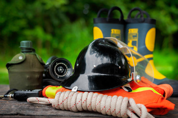 Outfit of Firefighter placed on nature background, Fire equipment concept.