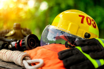 Outfit of Firefighter placed on nature background, Fire equipment concept.