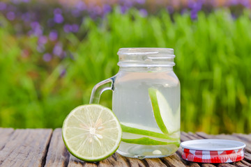 Lime detox water   in the morning on green nature background