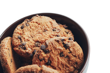 Chocolate cookies in a brown bowl on a white background