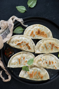 Close-up of roasted korean dumplings potstickers, view from above, vertical shot