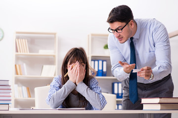 Male lecturer giving lecture to female student