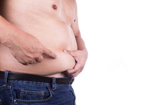 Man pinching unhealthy big belly with visceral or subcutaneous fats