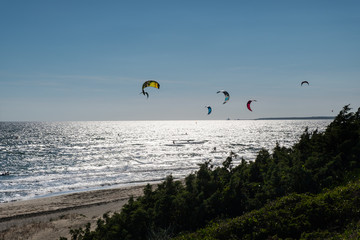 Summer sport background of kitesurf on a bright sunny day. Beautiful outdoor activity wallpaper.