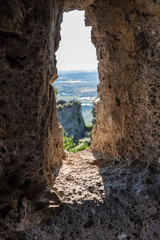 Vertical view of the landscape from an ancient medieval stone wall window. No people.